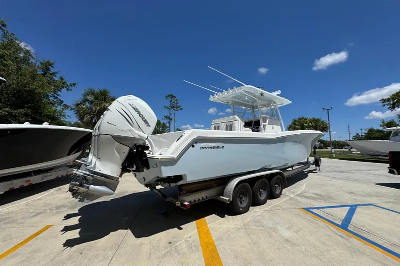  Yacht Photos Pics 2021 Invincible 36 Open Fisherman boat on trailer under clear blue sky.