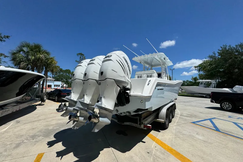  Yacht Photos Pics 2021 Invincible 36 Open Fisherman boat with triple outboard engines on a trailer.