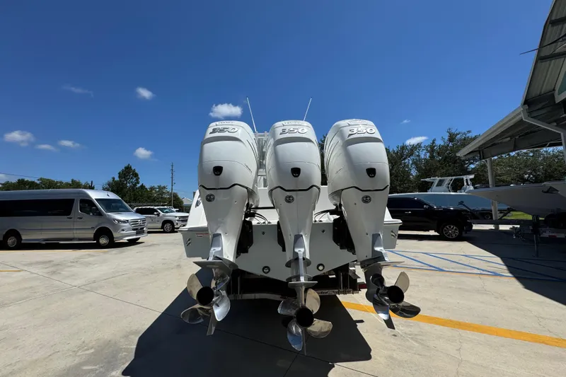  Yacht Photos Pics 2021 Invincible 36 Open Fisherman with triple 350 engines in a parking lot.