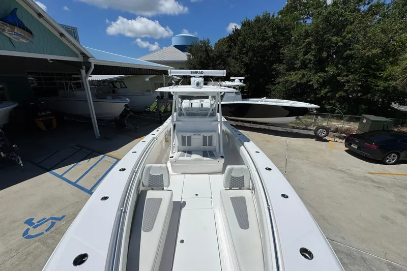  Yacht Photos Pics 2021 Invincible 36 Open Fisherman boat at a marina under a clear blue sky.