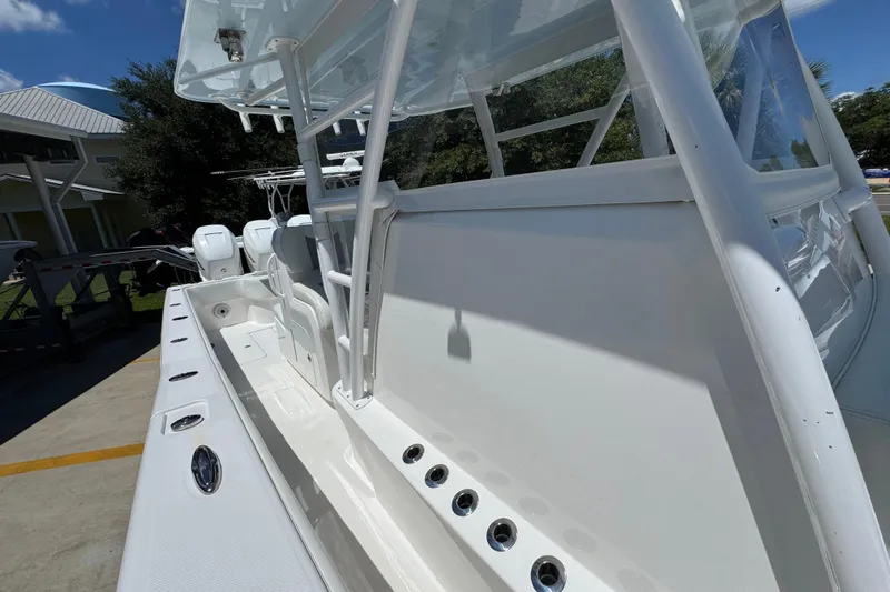  Yacht Photos Pics 2021 Invincible 36 Open Fisherman boat, sleek white design, docked outdoors.