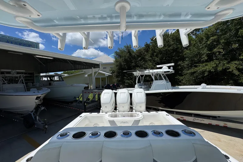  Yacht Photos Pics 2021 Invincible 36 Open Fisherman boat with triple engines in a marina setting.