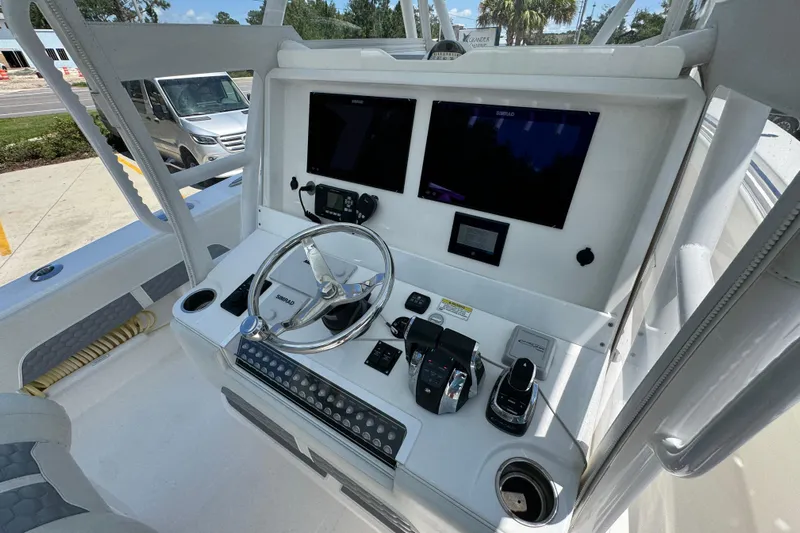  Yacht Photos Pics 2021 Invincible 36 Open Fisherman boat console with steering wheel and navigation screens.
