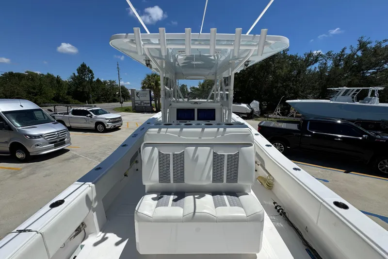  Yacht Photos Pics 2021 Invincible 36 Open Fisherman boat with seating, parked outdoors under clear blue sky.