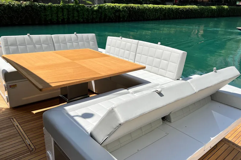 Yacht Photos Pics Luxurious seating area on 2026 Pardo Yachts GT52, featuring elegant white cushions and wooden table.