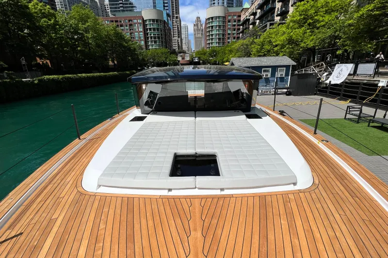  Yacht Photos Pics 2026 Pardo Yachts GT52 on a scenic urban waterway, showcasing sleek design and luxury features.