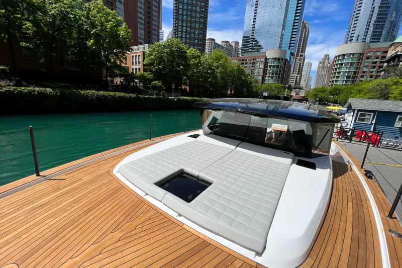  Yacht Photos Pics 2026 Pardo Yachts GT52 on a city river with modern skyscrapers.