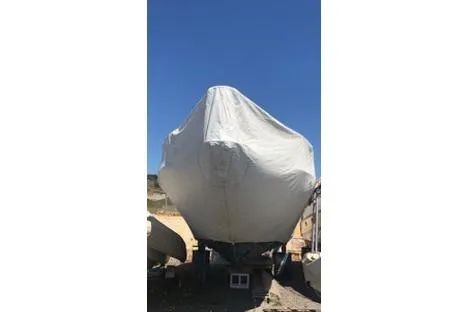  Yacht Photos Pics 2009 Scout 350 Abaco boat covered with tarp, parked outdoors under clear blue sky.