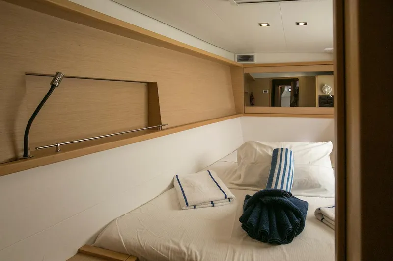 King Lewis Yacht Photos Pics Cozy cabin interior of 2016 Lagoon 450 yacht with neatly arranged towels.