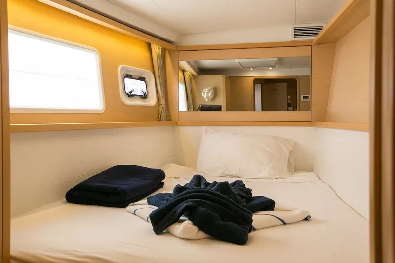 King Lewis Yacht Photos Pics Luxurious cabin interior of 2016 Lagoon 450 yacht with cozy bed and window view.