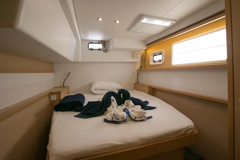 King Lewis Yacht Photos Pics Luxurious cabin interior of 2016 Lagoon 450 catamaran with cozy bed and natural lighting.
