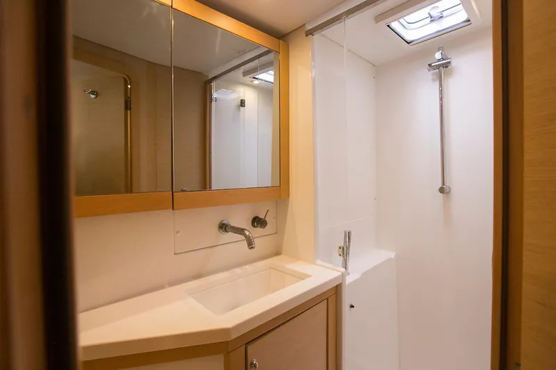King Lewis Yacht Photos Pics Modern bathroom interior on 2016 Lagoon 450 yacht, featuring sleek sink and shower.