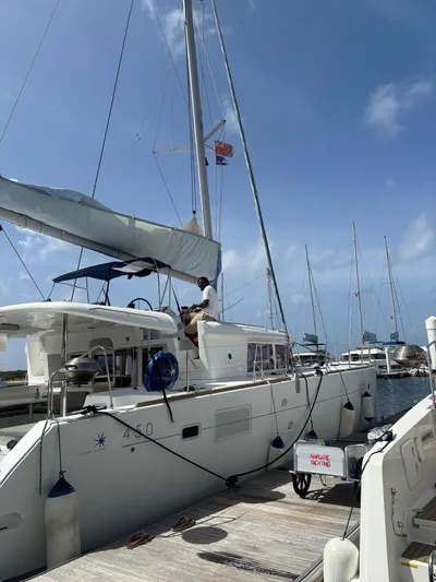 King Lewis Yacht Photos Pics 2016 Lagoon 450 catamaran docked at marina under clear blue sky.