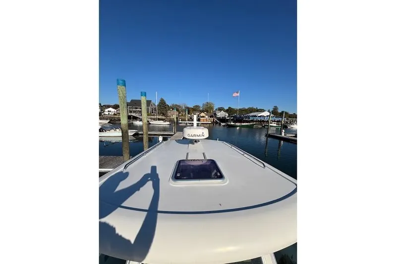 Hannah E Yacht Photos Pics 2018 Back Cove 30 boat docked at marina under clear blue sky.