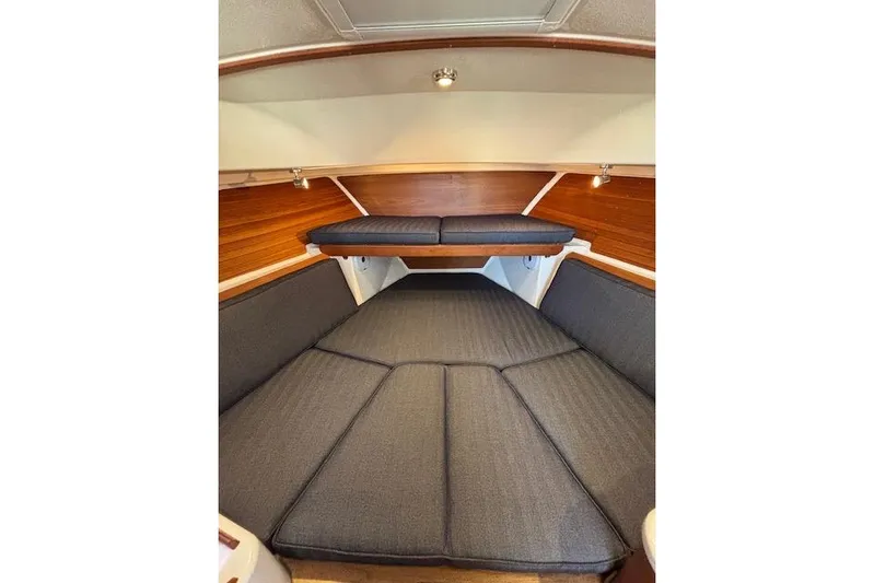 Hannah E Yacht Photos Pics 2018 Back Cove 30 interior cabin with cushioned seating and wooden accents.