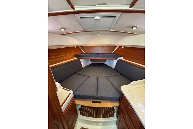 Hannah E Yacht Photos Pics 2018 Back Cove 30 interior cabin with wood accents and cushioned seating.