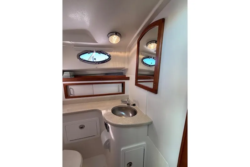 Hannah E Yacht Photos Pics 2018 Back Cove 30 yacht bathroom with sink, mirror, and porthole window.