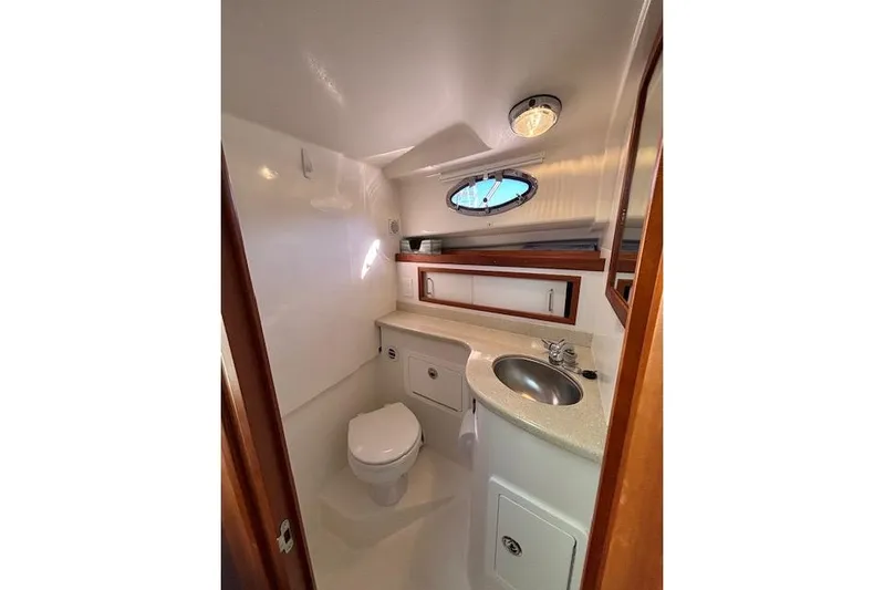 Hannah E Yacht Photos Pics Compact bathroom in a 2018 Back Cove 30 boat, featuring a toilet, sink, and storage.