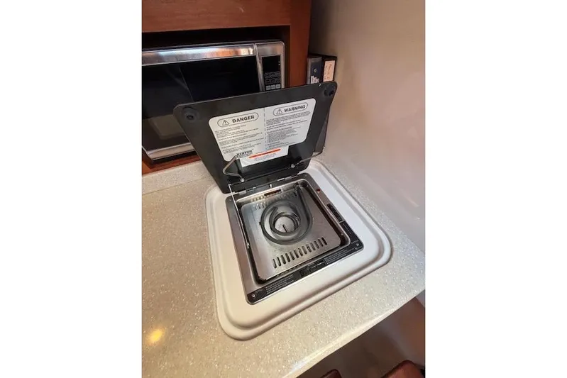 Hannah E Yacht Photos Pics Built-in stove on 2018 Back Cove 30 yacht, with safety warnings visible.