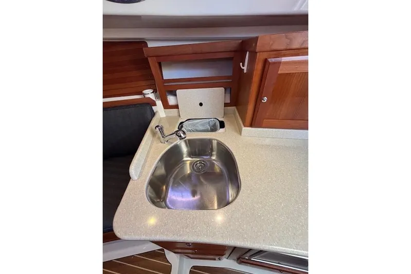 Hannah E Yacht Photos Pics 2018 Back Cove 30 yacht interior with stainless steel sink and wooden cabinetry.