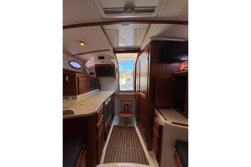 Hannah E Yacht Photos Pics Interior of 2018 Back Cove 30 yacht, featuring wood cabinetry and modern amenities.