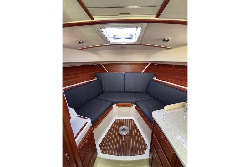Hannah E Yacht Photos Pics 2018 Back Cove 30 interior with cozy seating and wooden accents.