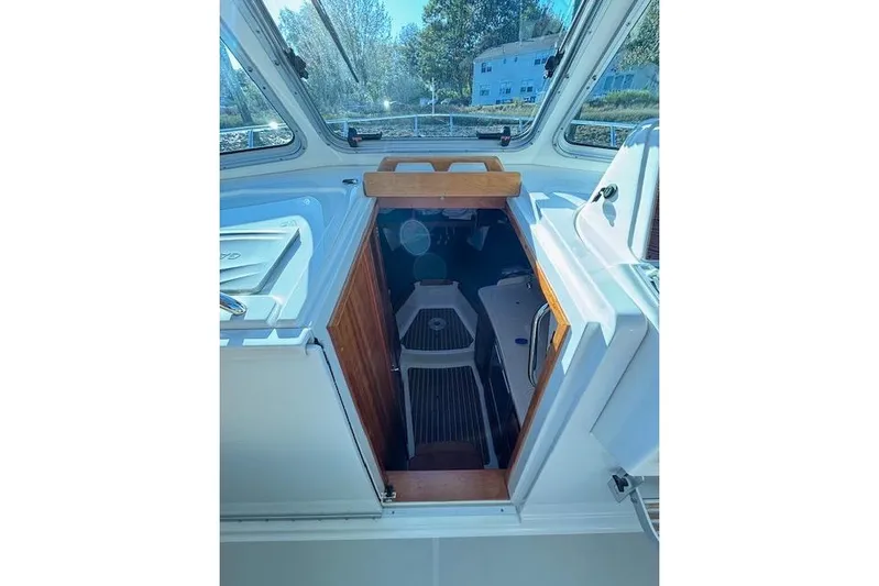 Hannah E Yacht Photos Pics 2018 Back Cove 30 boat interior with wooden hatch and seating area.