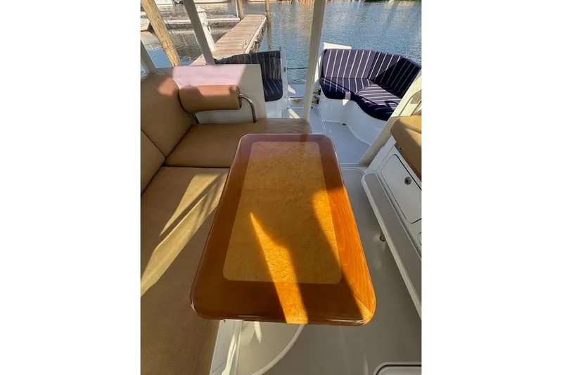 Hannah E Yacht Photos Pics Interior of 2018 Back Cove 30 boat with wooden table and cushioned seating.
