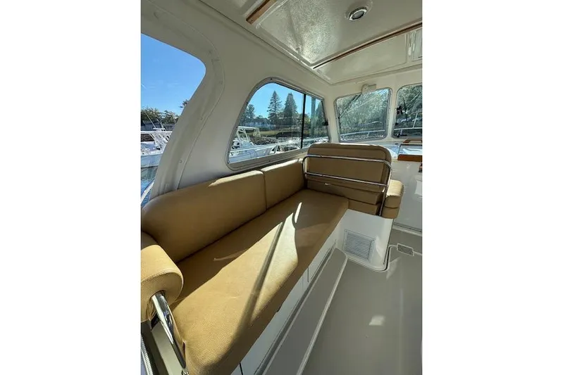 Hannah E Yacht Photos Pics Interior of 2018 Back Cove 30 boat with tan seating and large windows.