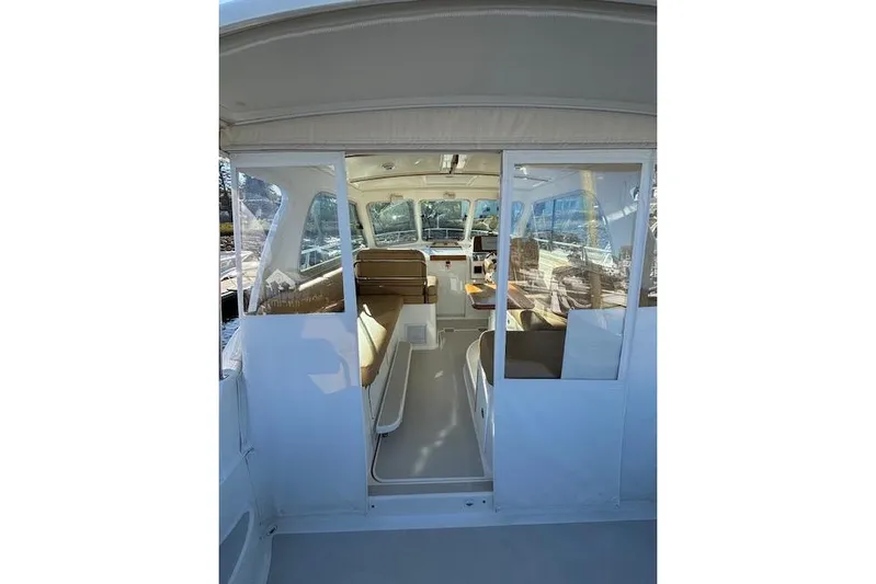 Hannah E Yacht Photos Pics 2018 Back Cove 30 boat interior with seating and helm, viewed from the entrance.