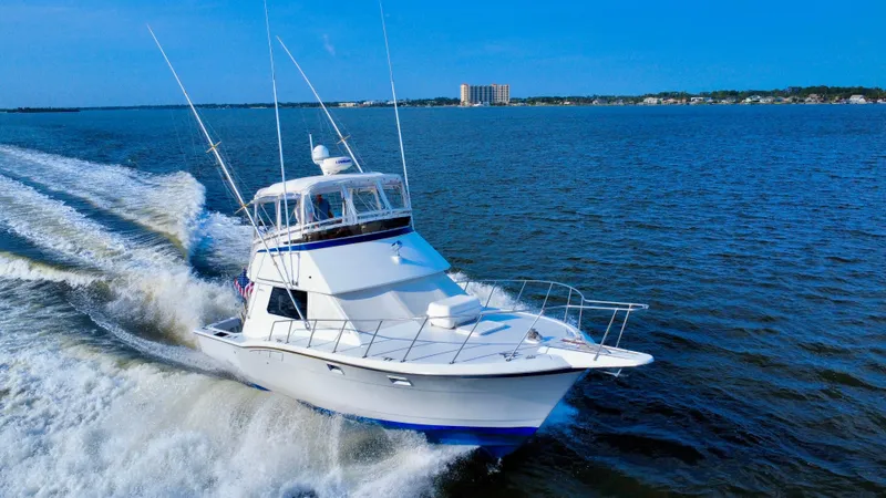 Reel Amnesia Yacht Photos Pics 1984 Hatteras 36 Convertible yacht cruising on open water.