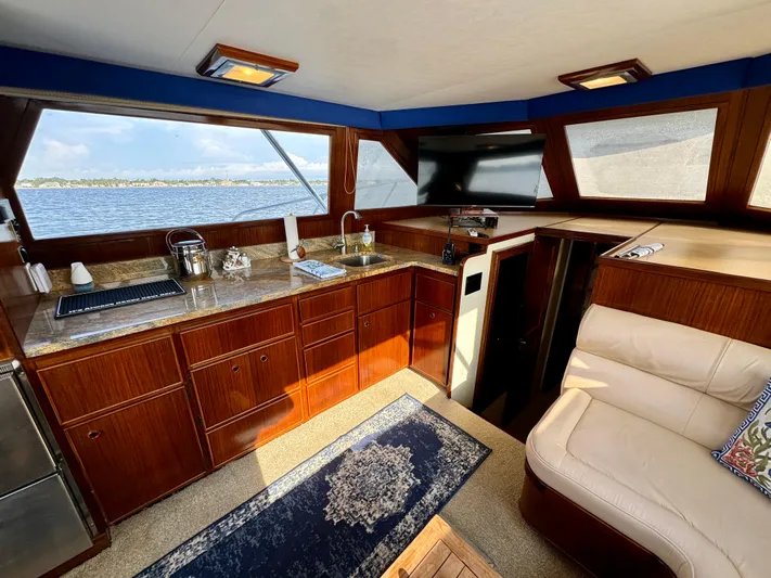 Reel Amnesia Yacht Photos Pics Interior of 1984 Hatteras 36 Convertible yacht with wood cabinetry and ocean view.