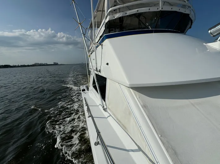 Reel Amnesia Yacht Photos Pics 1984 Hatteras 36 Convertible yacht cruising on open water under a clear sky.
