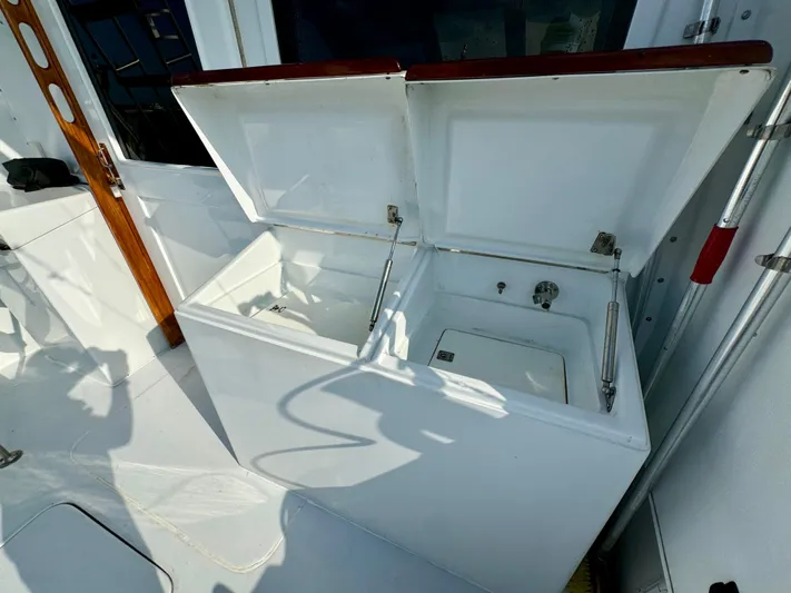 Reel Amnesia Yacht Photos Pics Open storage compartments on 1984 Hatteras 36 Convertible boat deck.