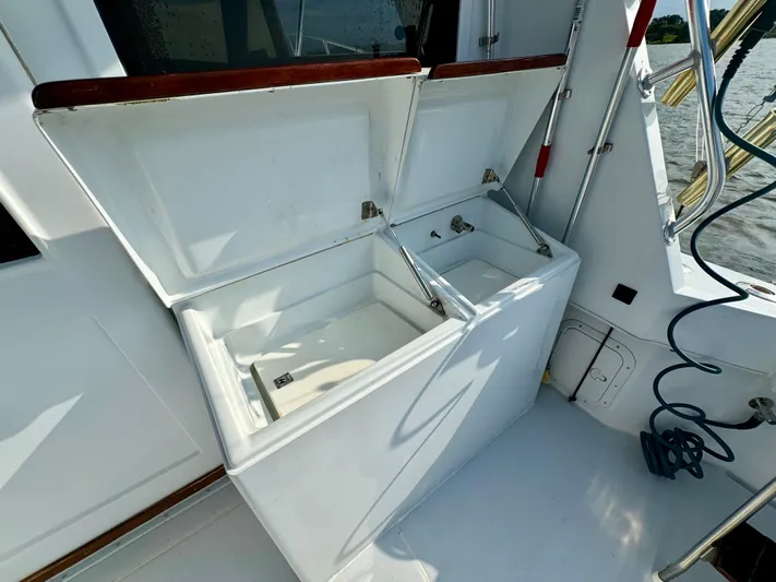 Reel Amnesia Yacht Photos Pics Open storage compartments on 1984 Hatteras 36 Convertible boat deck.