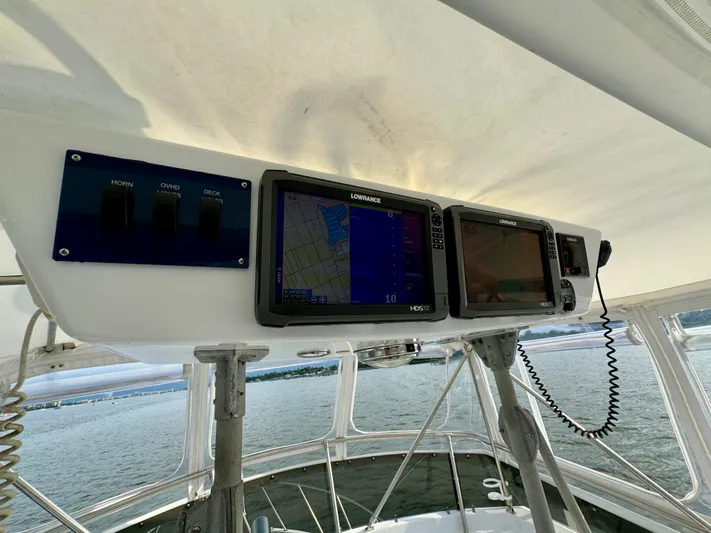 Reel Amnesia Yacht Photos Pics Control panel of a 1984 Hatteras 36 Convertible boat with navigation screens.