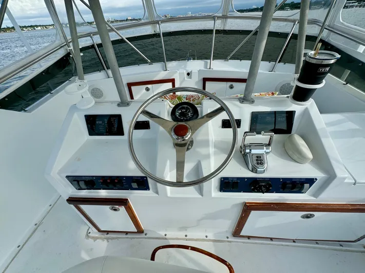 Reel Amnesia Yacht Photos Pics Cockpit of 1984 Hatteras 36 Convertible boat with steering wheel and controls.