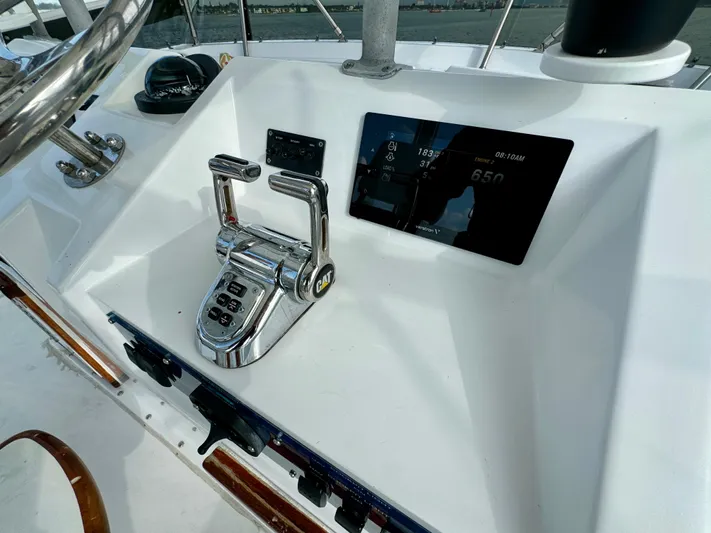 Reel Amnesia Yacht Photos Pics Control panel of a 1984 Hatteras 36 Convertible boat with throttle and display.