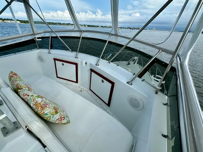 Reel Amnesia Yacht Photos Pics 1984 Hatteras 36 Convertible boat interior with cushioned seating and scenic water view.