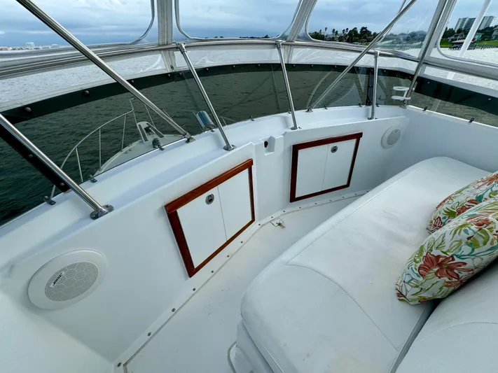 Reel Amnesia Yacht Photos Pics 1984 Hatteras 36 Convertible boat interior with white seating and floral cushions.