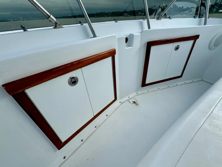 Reel Amnesia Yacht Photos Pics 1984 Hatteras 36 Convertible boat interior with wooden trim and storage compartments.