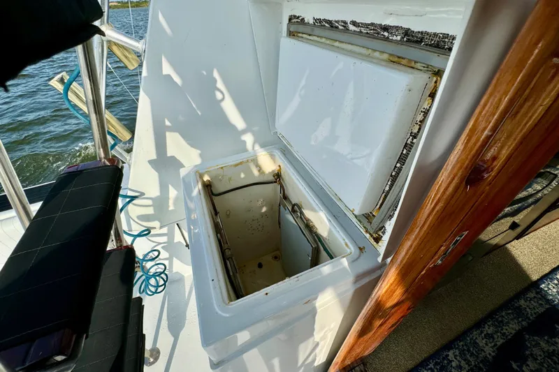Reel Amnesia Yacht Photos Pics Open storage compartment on 1984 Hatteras 36 Convertible boat deck.