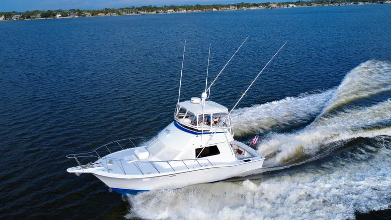 Reel Amnesia Yacht Photos Pics 1984 Hatteras 36 Convertible yacht cruising on open water.