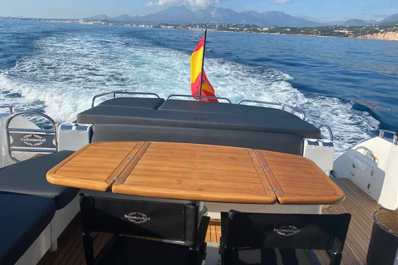  Yacht Photos Pics Sunseeker Predator 64 yacht, 2010 model, cruising with scenic coastal backdrop.