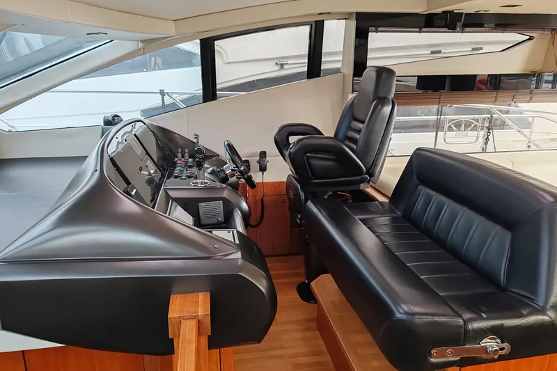  Yacht Photos Pics Interior helm of 2010 Sunseeker Predator 64 yacht with leather seating and control panel.