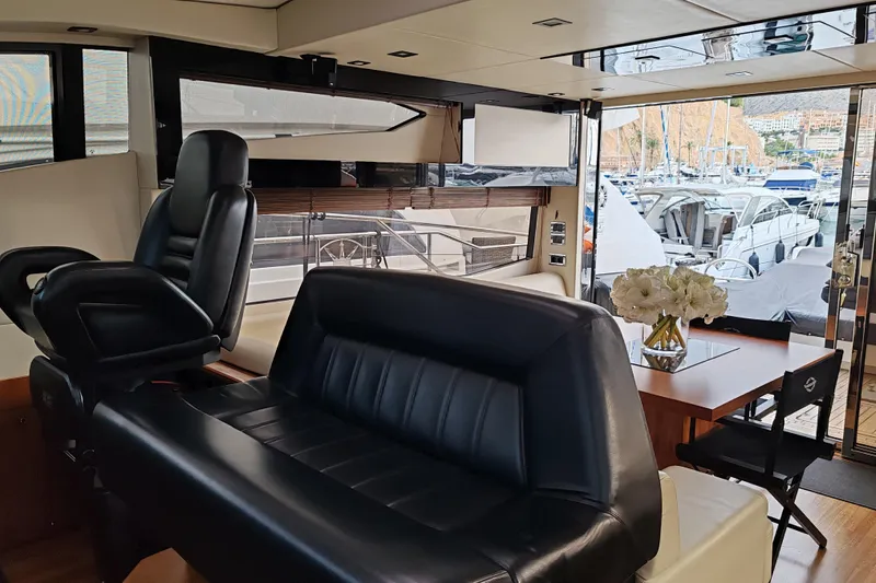  Yacht Photos Pics Luxurious interior of a 2010 Sunseeker Predator 64 yacht with leather seating and marina view.