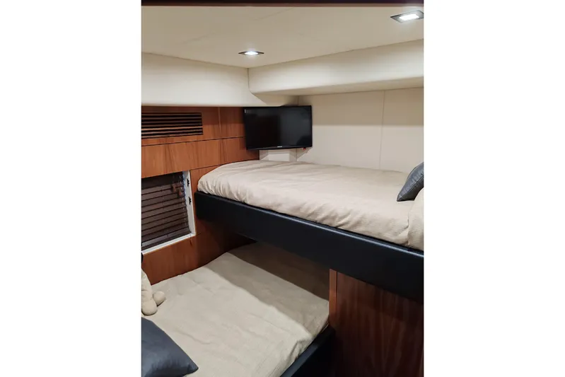  Yacht Photos Pics Interior of 2010 Sunseeker Predator 64 yacht with cozy bunk beds and modern lighting.