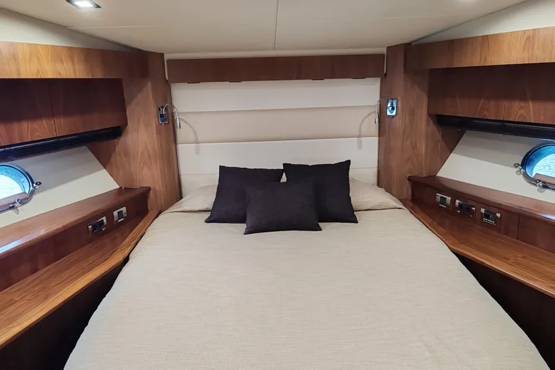  Yacht Photos Pics Luxurious bedroom interior of 2010 Sunseeker Predator 64 yacht with wood accents.