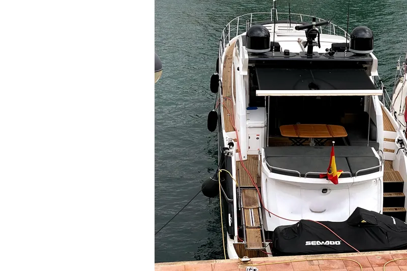  Yacht Photos Pics 2010 Sunseeker Predator 64 yacht docked with covered Sea-Doo on deck.