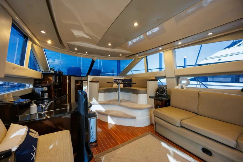 Why Knot Yacht Photos Pics Luxurious interior of 2010 Meridian 391 Sedan yacht with modern furnishings and panoramic windows.